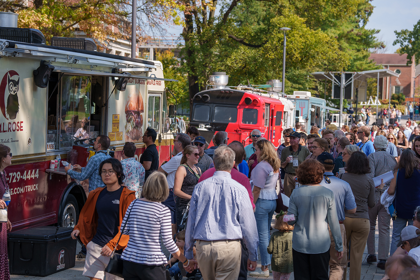 People mill around food trucks during Reunion.